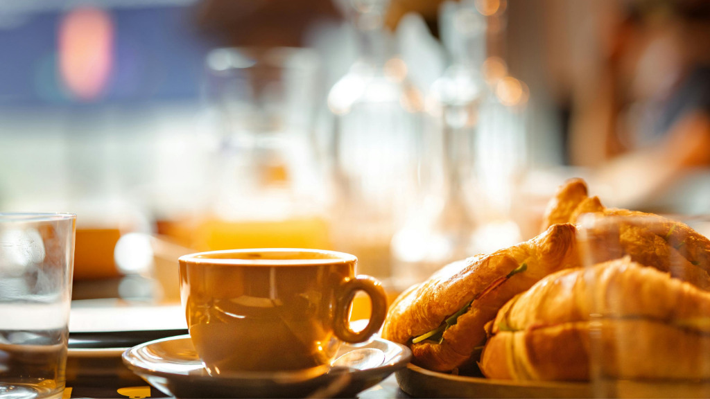 Specialty coffee and fresh pastries on a wooden board at Maison Bette