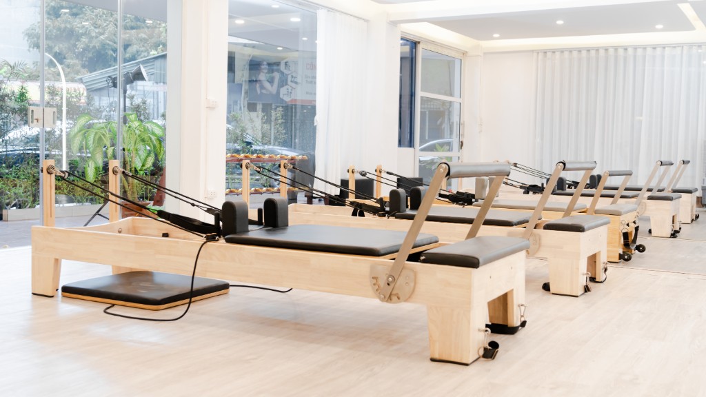 Empty Pilates studio with reformer machines lined up, fictional Studio Form space